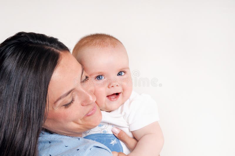 Portrait of a happy young mother near cute baby