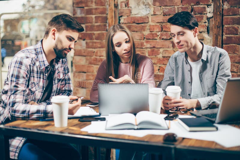 Portrait of happy young people in a meeting. Young designers working together on a creative project. stock photo Portrait of happy young people in a meeting. Young designers working together on a creative project. stock photo