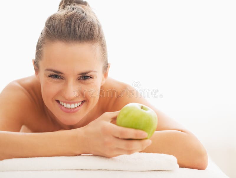 Portrait of Happy Young Woman with Apple Laying on Massage Table Stock ...