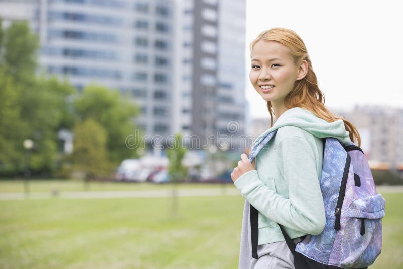 Portrait of Happy Young Woman with Backpack at College Campus Stock