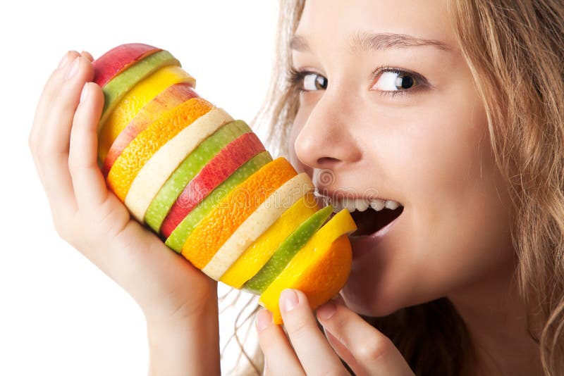 Portrait of happy young woman holding fruits