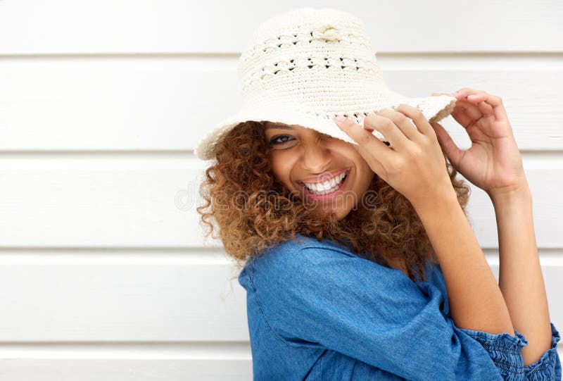 Portrait of a happy young woman wearing hat