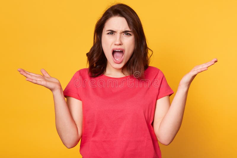 Portrait haut étroit de la brune déçue fâchée criant avec mécontentement, ouvrant sa bouche largement, regardant directement photo stock Portrait haut étroit de la brune déçue fâchée criant avec mécontentement, ouvrant sa bouche largement, regardant directement photo stock