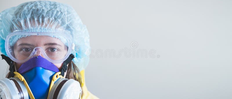 Portrait of a healthcare worker woman in protective glasses and respirator mask.