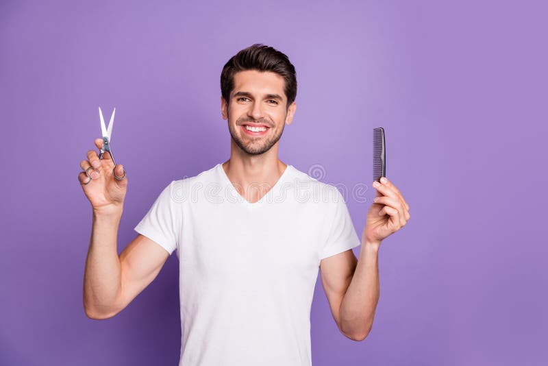 Portrait of his he nice attractive groomed cheerful brown-haired guy holding in hands comb scissors choosing solution royalty free stock photos