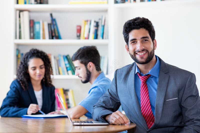 Portrait of hispanic businessman with group of latin american business people stock image