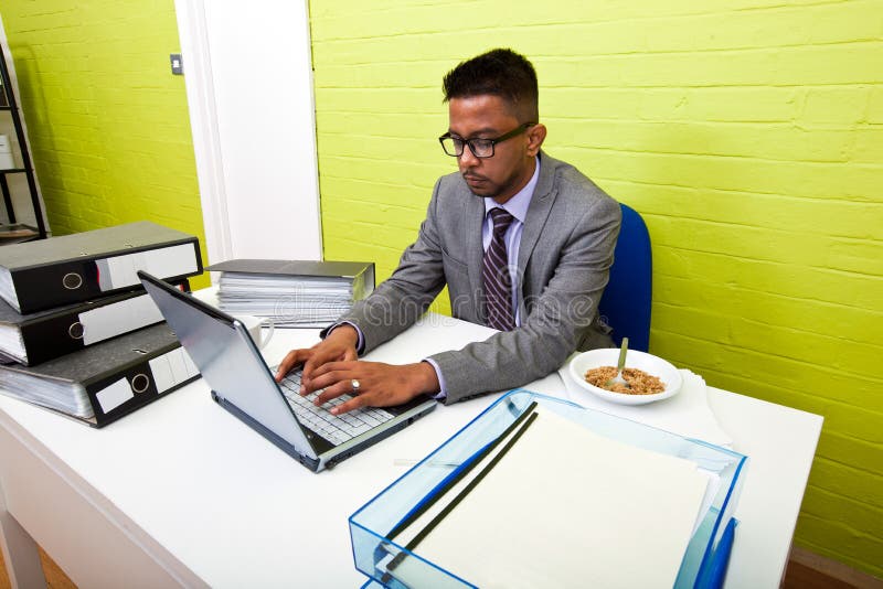 Portrait of Indian Businessman working on his laptop computer at his desk stock photos