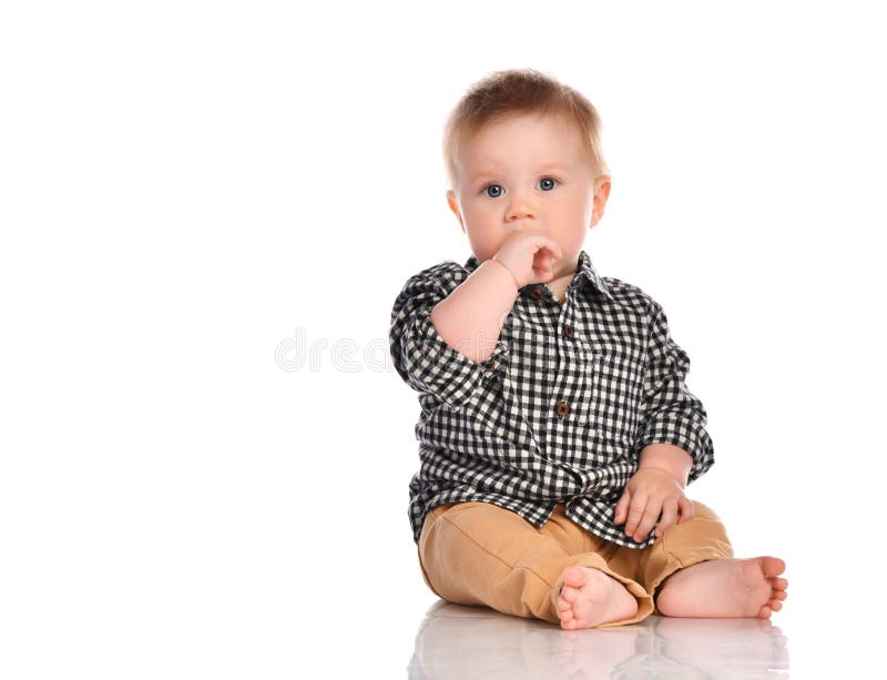 Portrait of infant child baby boy toddler with dark blue eyes. Portrait of infant child baby boy toddler with dark blue eyes dressed in beige pants and a stock images Portrait of infant child baby boy toddler with dark blue eyes. Portrait of infant child baby boy toddler with dark blue eyes dressed in beige pants and a stock images
