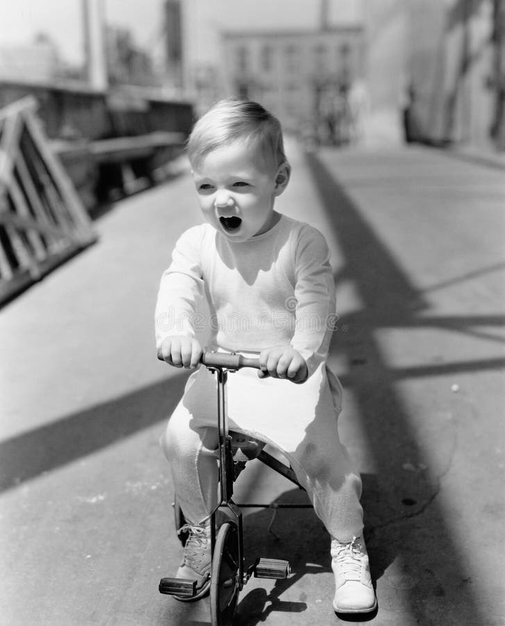 kid riding tricycle