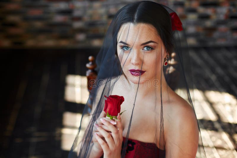 Portrait Of A Latin Brunette Girl With A Rose In Her Hair Stock Image