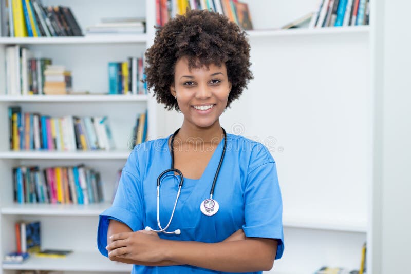 Portrait of laughing african american nurse at work