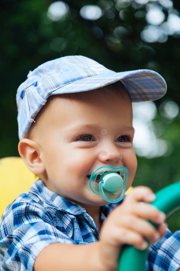 Portrait of a laughing baby with pacifier