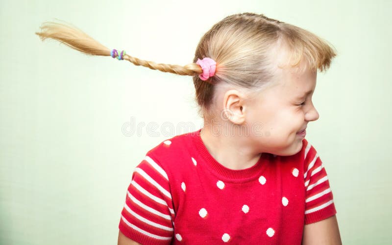 Portrait of laughing little girl with pigtails