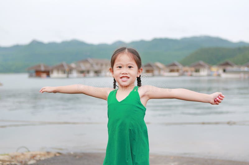 Portrait of Little Asian Child Girl Stretch Arms and Relaxes in ...