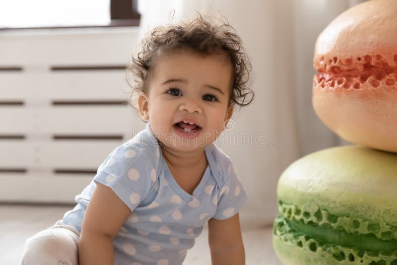 Portrait of little biracial baby playing at home