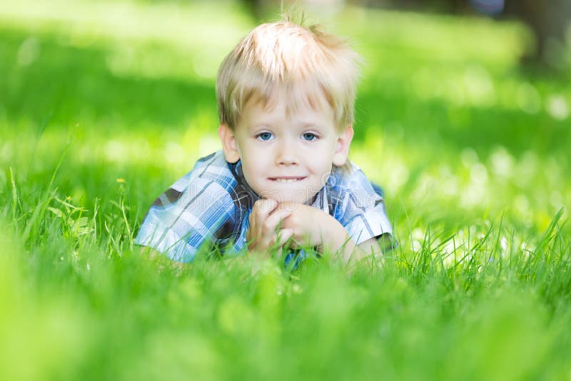 Little Boy Laying on the Grass Loan in the Park Stock Image - Image of ...