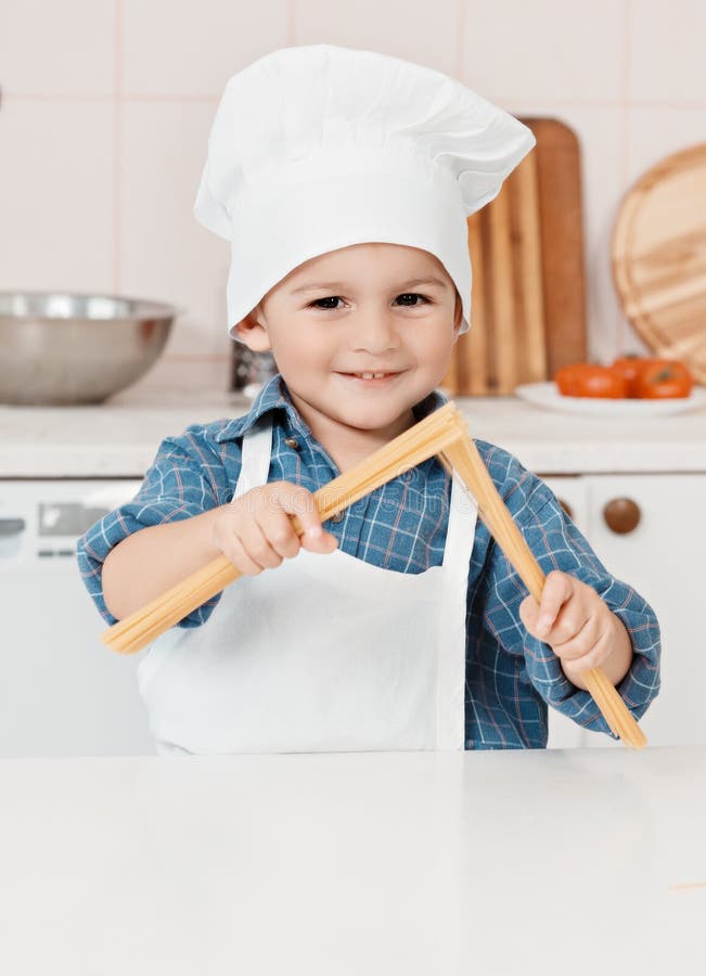 Little boy holding a spaghetti cook in the hands of. Little boy holding a spaghetti cook in the hands of
