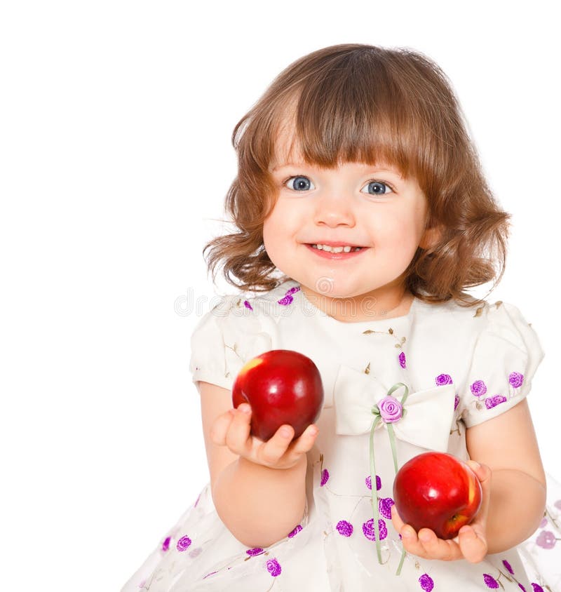 Portrait of a little girl eating apples
