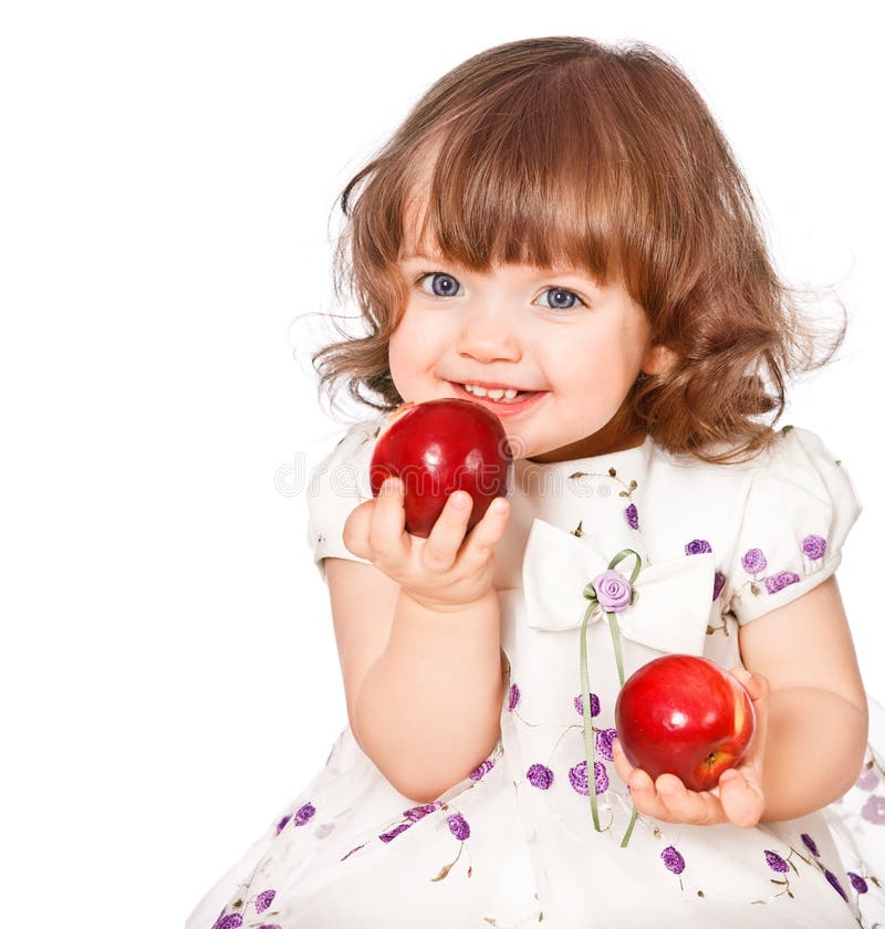 Portrait of a little girl eating apples