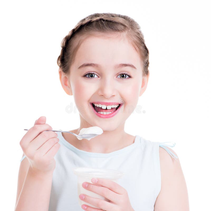 Portrait of a little girl eating yogurt. royalty free stock photos Portrait of a little girl eating yogurt. royalty free stock photos