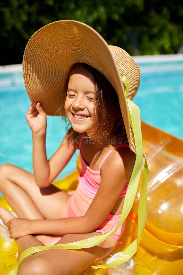 Little Girl in Hat Relaxing in Swimming Pool, Swims on Inflatable Yellow  Mattress Stock Image - Image of lying, enjoy: 189240569