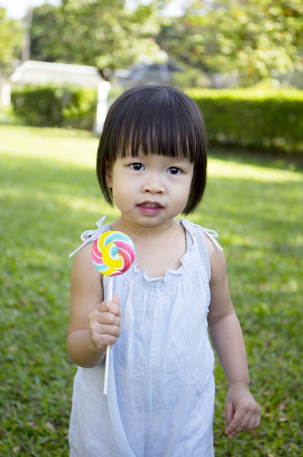 Portrait of a little girl with lollipop stock photo