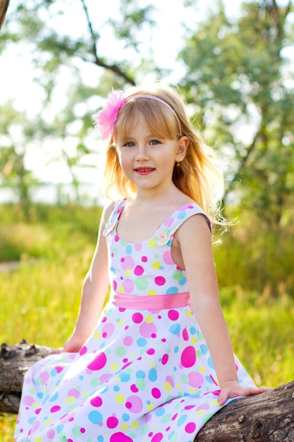 Portrait of Little Girl Sitting on a Tree Branch Stock Photo - Image of ...