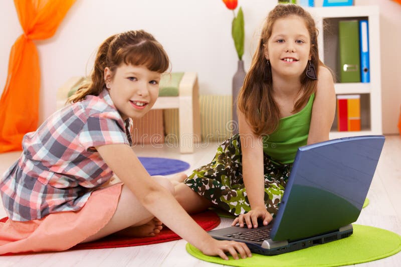 Portrait of little girls with laptop
