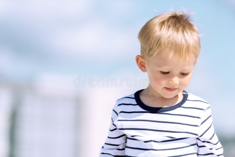 Portrait of little preschool boy outdoors copy space.