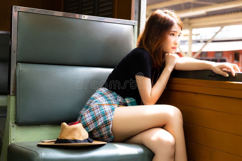 Portrait loneliness beautiful woman. Charming beautiful girl feels lonely and looking outside the train window. Pretty girl gets homesick and miss her family during she goes to a city for working