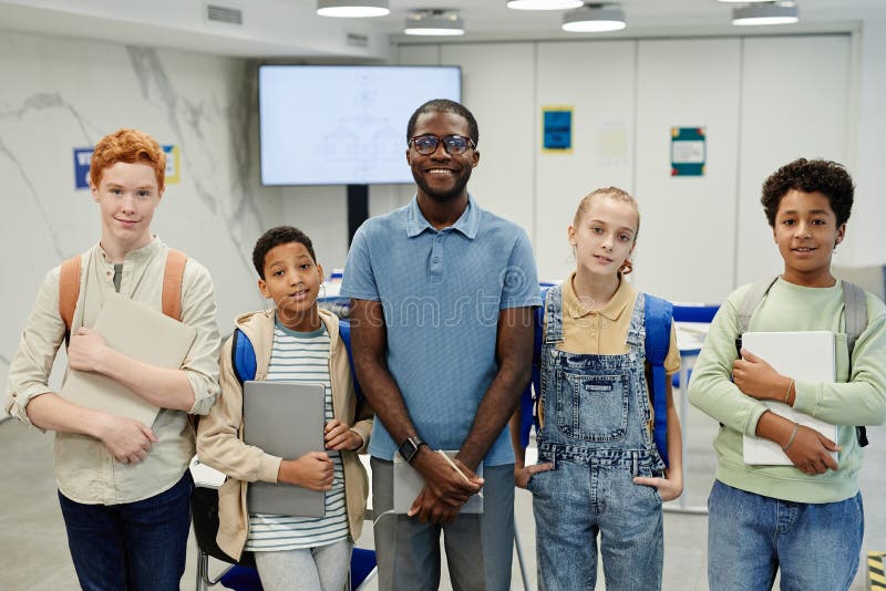 Smiling Teacher with Group of Kids stock image