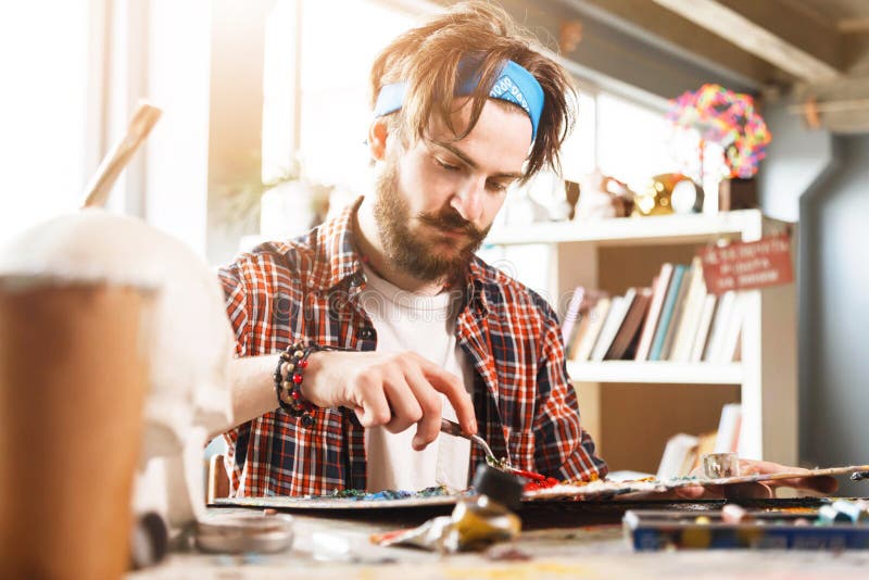 Portrait Of Male Artist Working On Painting In Studio stock photo Portrait Of Male Artist Working On Painting In Studio stock photo