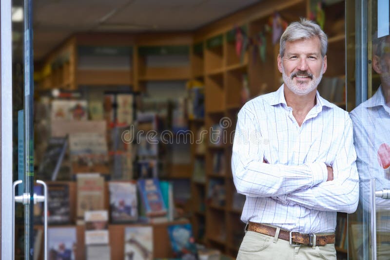 Portrait Of Male Bookshop Owner Outside Store stock image Portrait Of Male Bookshop Owner Outside Store stock image