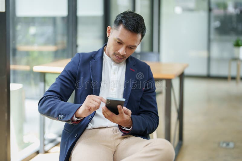Portrait of a Male Business Owner Using a Mobile Phone Stock Photo