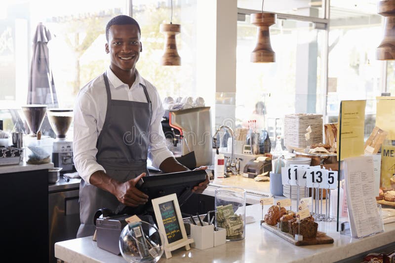 Portrait Of Male Employee Working At Delicatessen Checkout stock photo