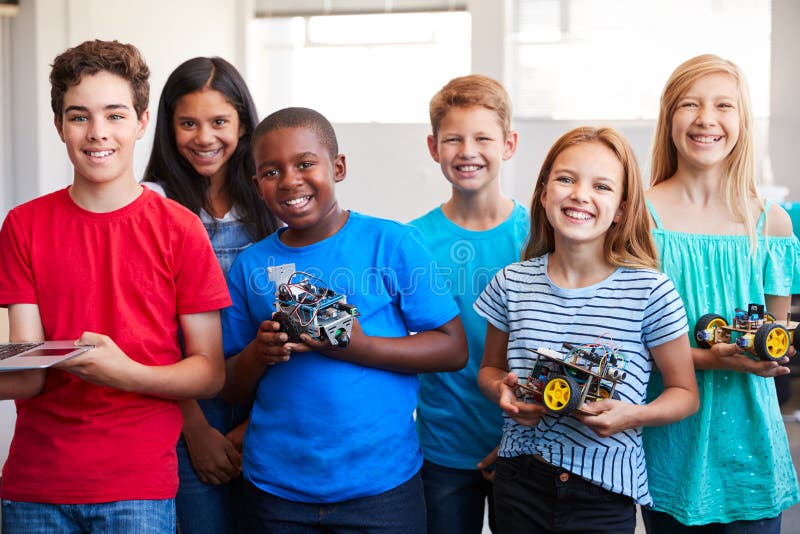 Portrait Of Male And Female Students Building Robot Vehicle In After School Computer Coding Class royalty free stock photo