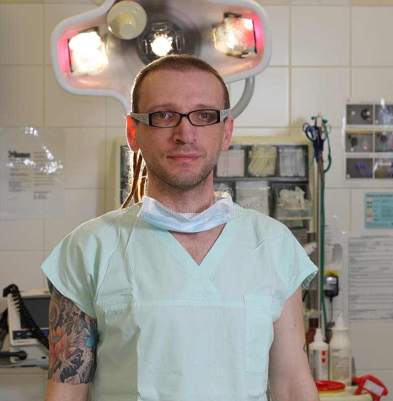 Portrait of male nurse ICU with tattoo and dreadlocks. 