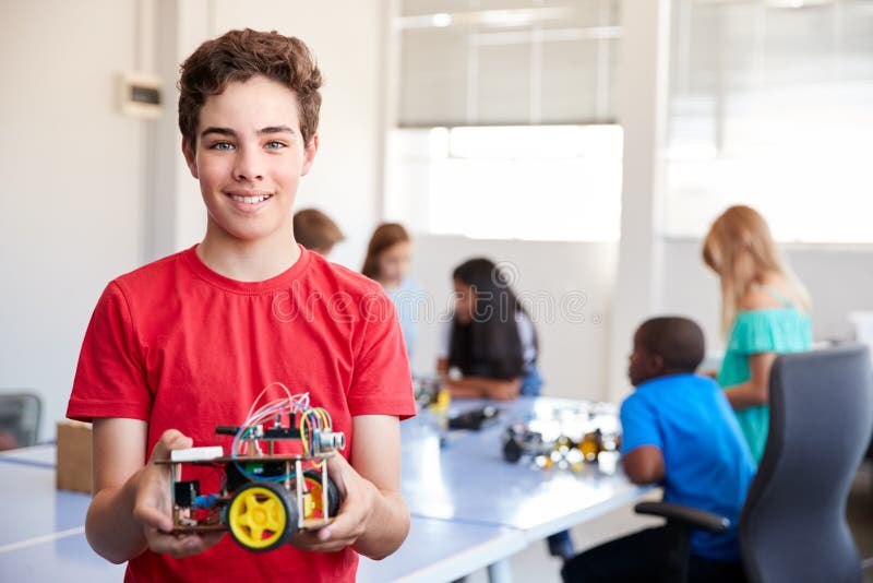 Portrait Of Male Student Building Robot Vehicle In After School Computer Coding Class stock image