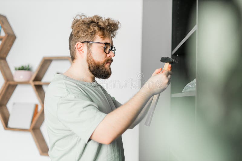 Portrait of Man Assembling Furniture. Do it Yourself Furniture Assembly at Home Stock Image