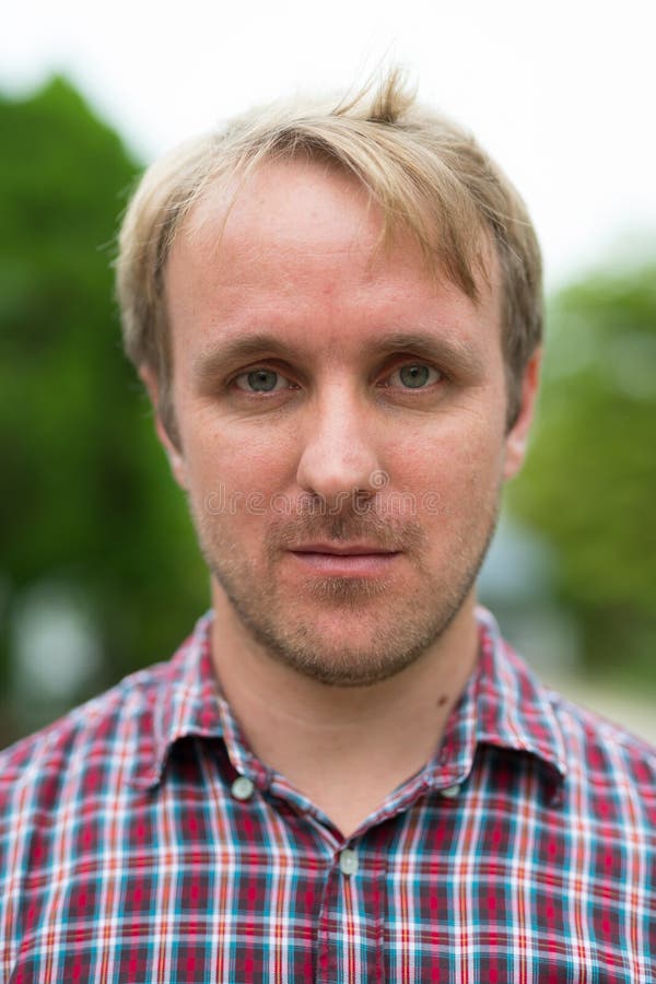 Head shot of man with blonde hair outdoors stock photo Head shot of man with blonde hair outdoors stock photo