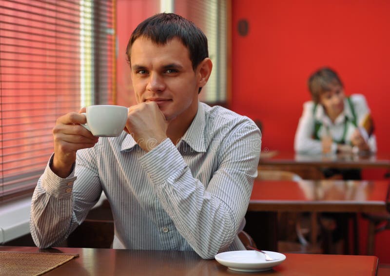 Portrait of man in cafe with cup of coffee