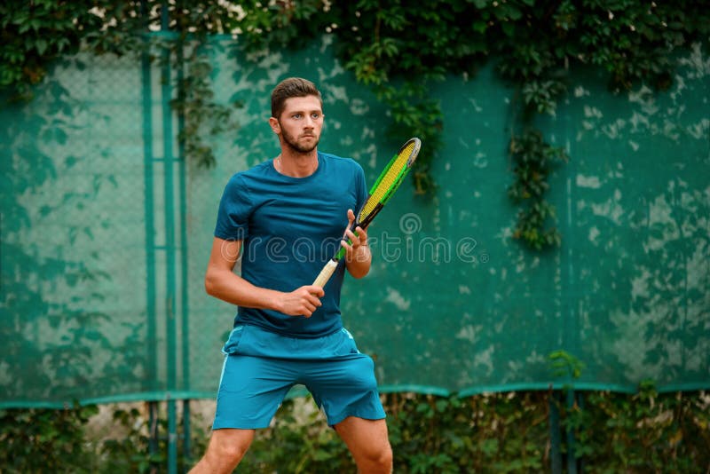 Portrait of a man holding a tennis racket stock photo