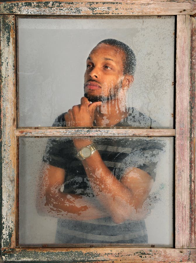 Portrait of Man Looking Through Window