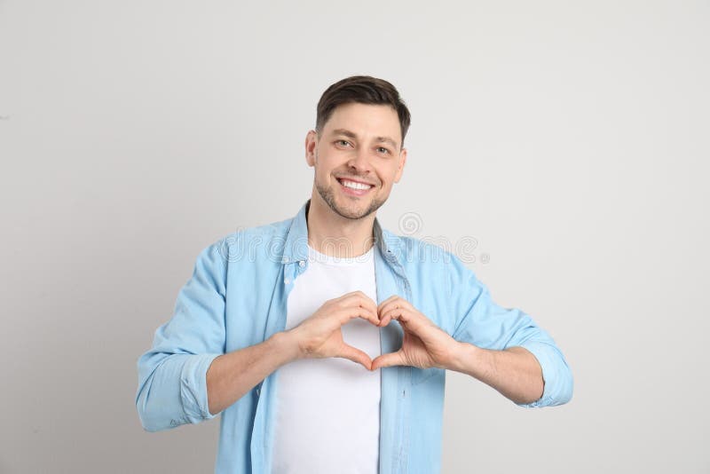 Portrait of man making heart with his hands