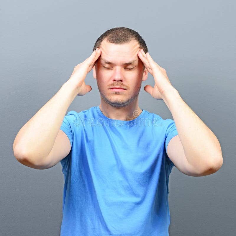 Portrait of a man putting fingers on forehead and trying to concentrate royalty free stock photography Portrait of a man putting fingers on forehead and trying to concentrate royalty free stock photography
