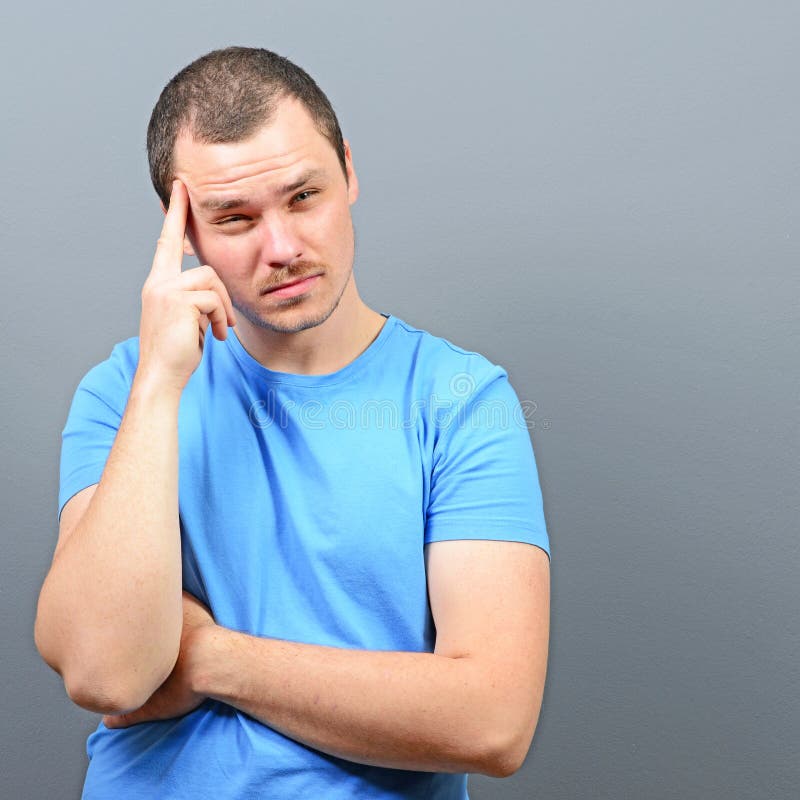 Portrait of a man putting fingers on forehead and trying to concentrate royalty free stock image Portrait of a man putting fingers on forehead and trying to concentrate royalty free stock image