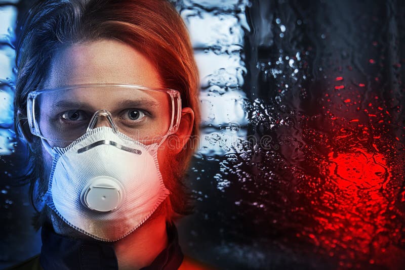 Portrait Of Man In Respirator Over Rainy Window
