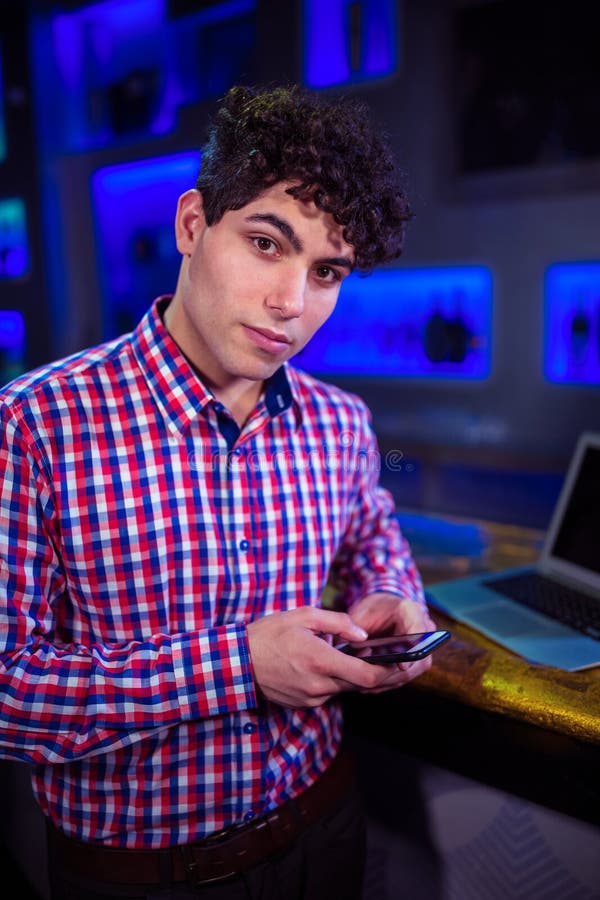 Portrait of man using mobile phone by bar counter royalty free stock image