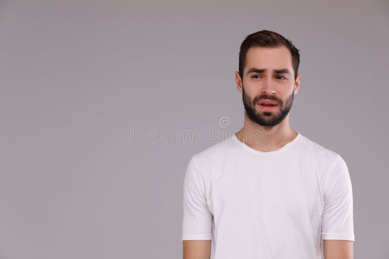 Portrait of a man in a white T-shirt on a gray background royalty free stock photography Portrait of a man in a white T-shirt on a gray background royalty free stock photography