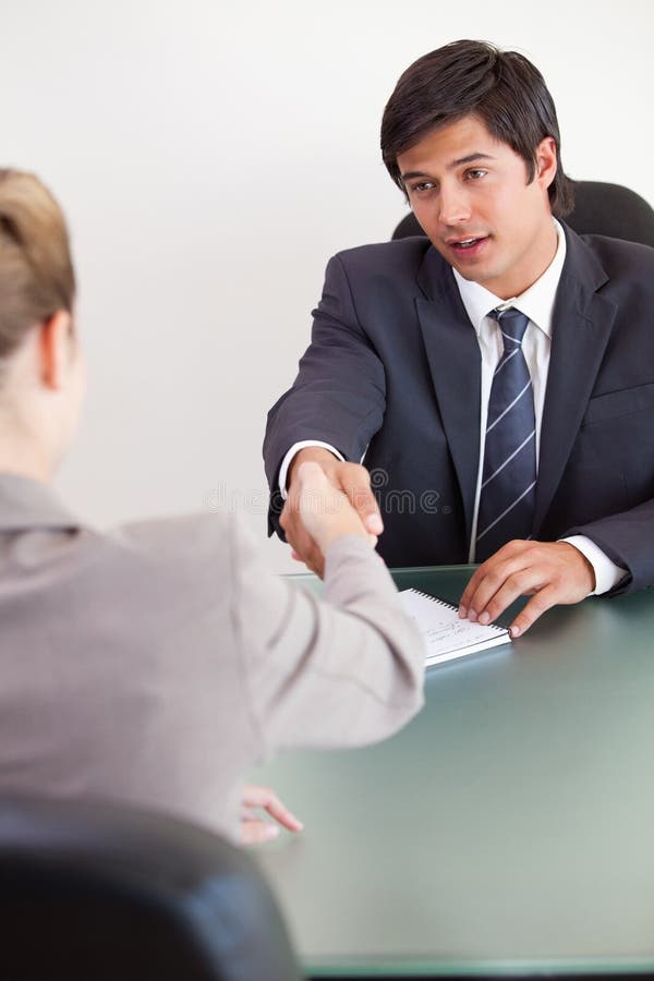 Portrait of a manager shaking the hand of a customer royalty free stock images